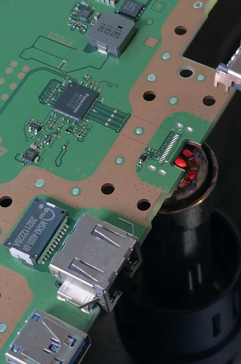 Étape 1 : l'ancien port HDMI est dessoudé à l'air chaud. On voit les pastilles vides sur la carte.